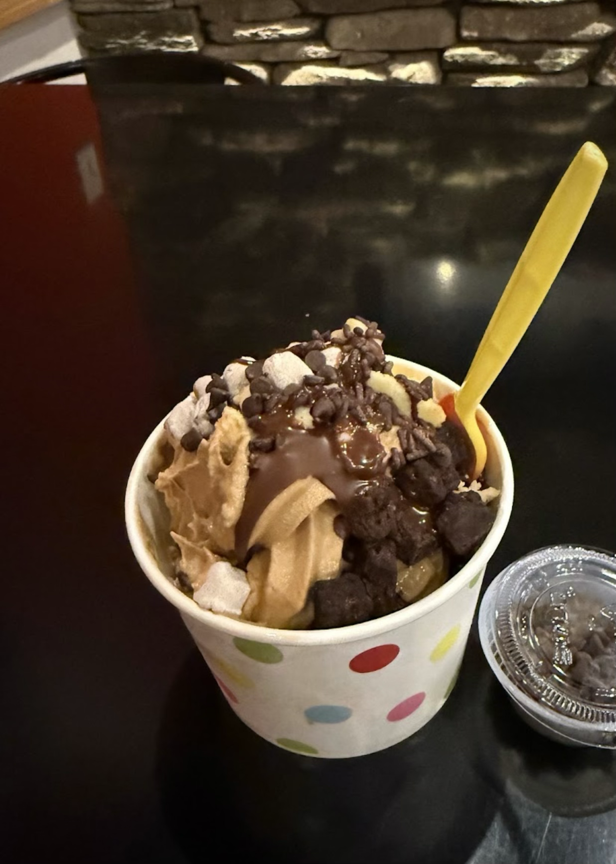 Frozen yogurt cup loaded with chocolate chips, brownie bites and marshmallows